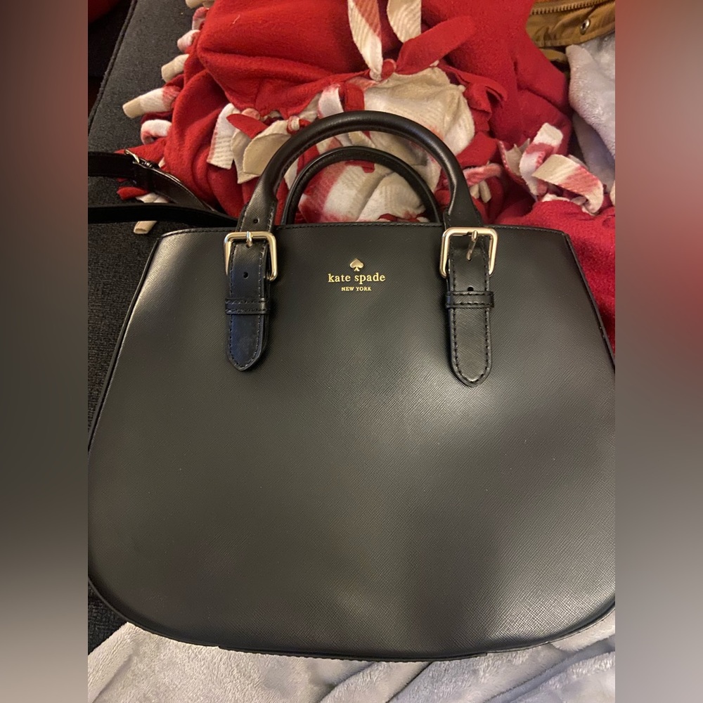 Black, leather, Kate Spade bag with wash bag.